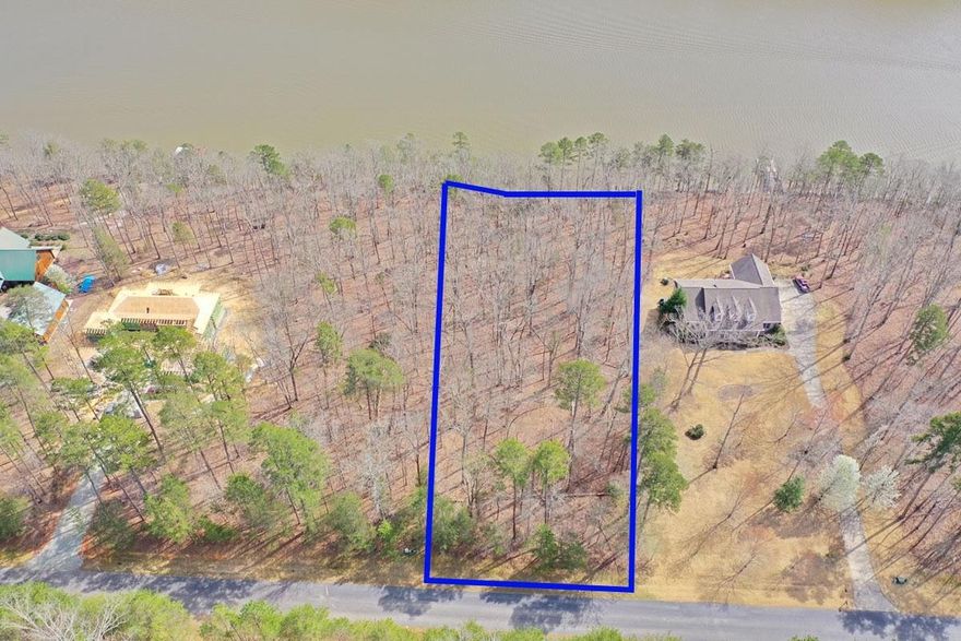 Picturesque Lakefront lot nestled in the “Flat Swamp” channel of High Rock Lake with some of the best fishing on a 360 mile shoreline. Stoney Point Harbor is a gated subdivision with a community boat ramp and docking pier; fenced boat/trailer storage area; paved roads and street lights. This undeveloped prime lot will have a shared pier with Lot 20 which is currently is not built yet. All lots require septic & well. This incredible 1.07 acre property offers an incredible potential for building a dream home or vacation getaway. Surrounded by lush greenery and panoramic views of the water, it has the potential to become a luxurious retreat that offers a perfect blend of relaxation and recreation.