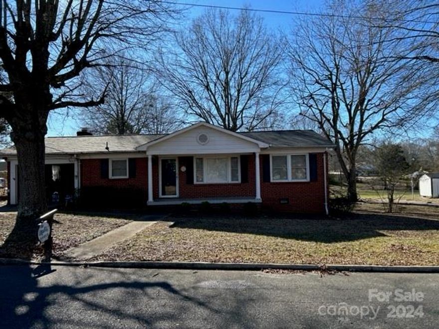 What a very convenient location where this home is located! Enjoy the massive deck this home has to offer plus a huge great room with fireplace and trey ceiling. The home was originally a 3 bedroom house but a wall was removed years ago to make it a 2 bedroom home. (wall could easily be installed to make a 3rd bedroom). The living room could also be made into a bedroom with adding a closet and a wall to make the front door area into a foyer/hall. The kitchen is open to the dining area and there is a large entrance into the great room. Enjoy the sunroom off of the great room enjoy the deck that wraps around from the sunroom to the back of the home. This property also has a very nice building that was using as a craft/sewing room and then there is a building for car storage, etc. Home needs some updates but is priced "as is!" This property is made up of 2 lots.