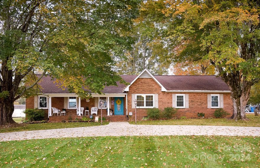 Are you looking for just the right home in an All-American small town? You've found it! This beautiful four-bedroom home is located on a large corner lot right in the heart of Mocksville (named 2023 All-American County)! Just a short drive from historic downtown Mocksville, shopping and dining. A few of the features you will find in your new home include some gorgeous hardwood floors, spacious bedrooms and a huge family room! Enjoy beautiful days on the screened porch or gather everyone by the fire in the family room! The kitchen includes stainless steel appliances and the option for natural gas cooking. Additional storage and workspace in the two outbuildings that include electricity! Updates include soffit, gutters, flashing, chimney cap, and partial roof in 2020. Schedule your showing today!