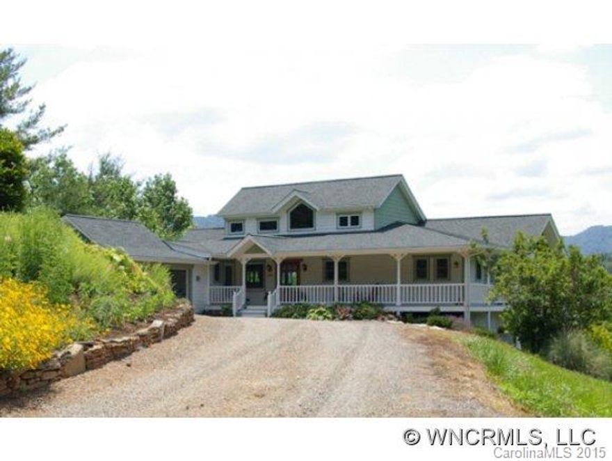 Wonderful country estate on a 14 acre private cove in the Jacks Creek Valley of Yancey Co. Custom-built home features 2 stories w/spacious wrap around terraces & porches overlooking distant mountain views. Interior has finely finished woodwork throughout & gleaming cherry floors & cabinets. The great room design has expansive windows that invites the outdoors in! Features vaulted ceilings, gourmet kitchen, master suite on main.
