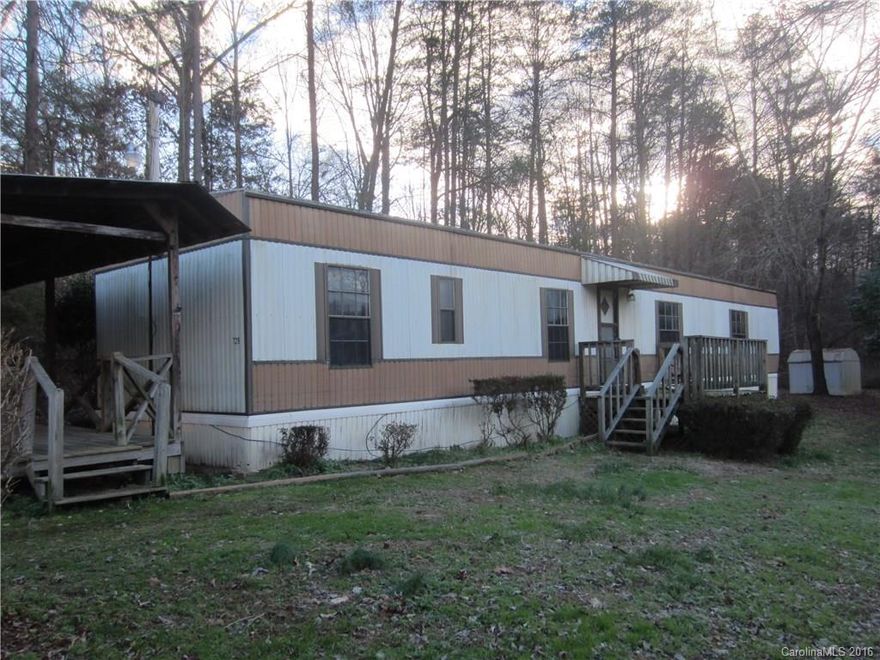2 bedroom, 2 bath single wide with covered porch and deck. Home features kitchen, breakfast area, living room with wood beam ceiling, split floor plan with large master suite. Located close to Lake Norman.