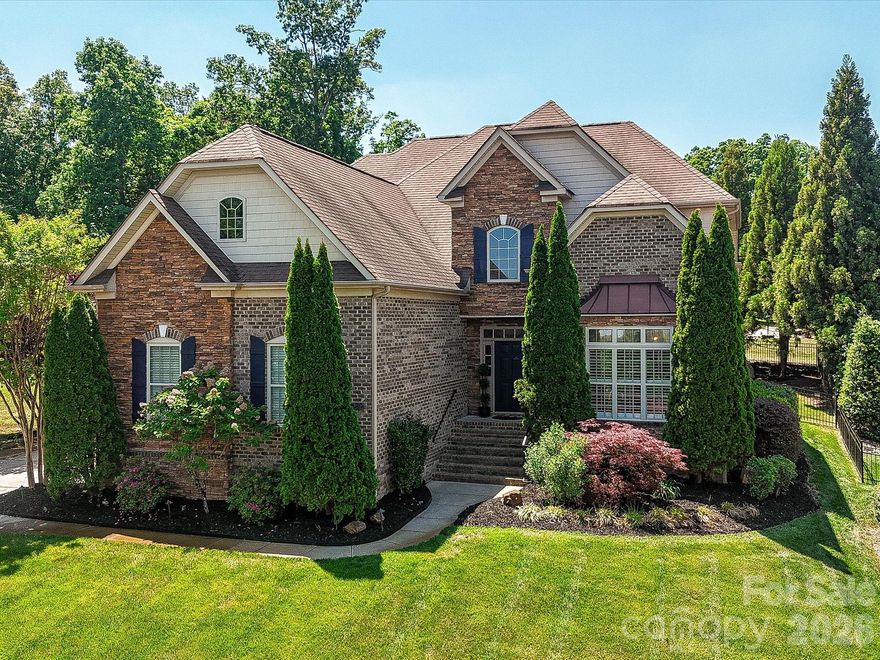 Step into elegance and comfort in this beautifully appointed home where thoughtful design meets timeless finishes. Full Brick/Stone exterior, Primary suite is on the main floor, 3 Additional bedrooms upstairs, a huge Bonus room and 3.5 baths in the home.
A welcoming foyer opens to a formal sitting and dining room, highlighted by vaulted ceilings and detailed millwork—perfect for hosting gatherings or enjoying quiet moments in style. Rich oak hardwood floors flow throughout the main level, complemented by plantation shutters on the main level that add charm and privacy across the entire home.
The heart of the home is a stunning two-story great room featuring a dramatic floor-to-ceiling stone gas fireplace, creating a warm and inviting focal point. The adjoining kitchen is a chef’s dream, complete with granite countertops, stainless steel appliances, cherry cabinetry, a walk-in pantry, wall oven and microwave, and a vented hood over the electric cooktop. A bright breakfast area offers the perfect spot to start your day.
Seamless indoor-outdoor living awaits with double patio doors that fully open to a covered and screened porch showcasing travertine tile flooring, a gorgeous wood ceiling, elegant ceiling fan and pull-down shades. Step out onto the deck with Trex treads overlooking a beautifully landscaped, fully fenced backyard with sleek black aluminum fencing—ideal for entertaining or relaxing in your private oasis.
The spacious main-level primary suite is a true retreat, featuring a dramatic octagon tray ceiling and a recently renovated spa-like bath with a large dual-sink vanity, soaking tub, separate shower, private water closet, and a custom walk-in closet. Convenience continues with a main-level half bath and a well-equipped laundry room with a utility sink.
Upstairs, you’ll find brand new carpeting, two secondary bedrooms sharing a hall bath with dual sinks, plus an oversized guest suite with its own private bath—perfect for visitors. A massive bonus room with closets offers endless possibilities as a media room, playroom, or home office.
Additional highlights include a three-car side-load garage, a charming stone pathway leading to the backyard, an irrigation system with a dedicated well, a whole-house saltwater filtration system, fresh paint and 2 HVAC units replaced in 2022 with compressors warranted through 2032—providing comfort, efficiency, and peace of mind.
This exceptional home truly has it all—and it is conveniently located a few minutes from I-485 so you can get everywhere with ease. Only 20 minutes from Concord Mills and 15 miles to Uptown Charlotte. Neighborhood amenities include an outdoor pool, tennis court, playground, club house and sidewalks.