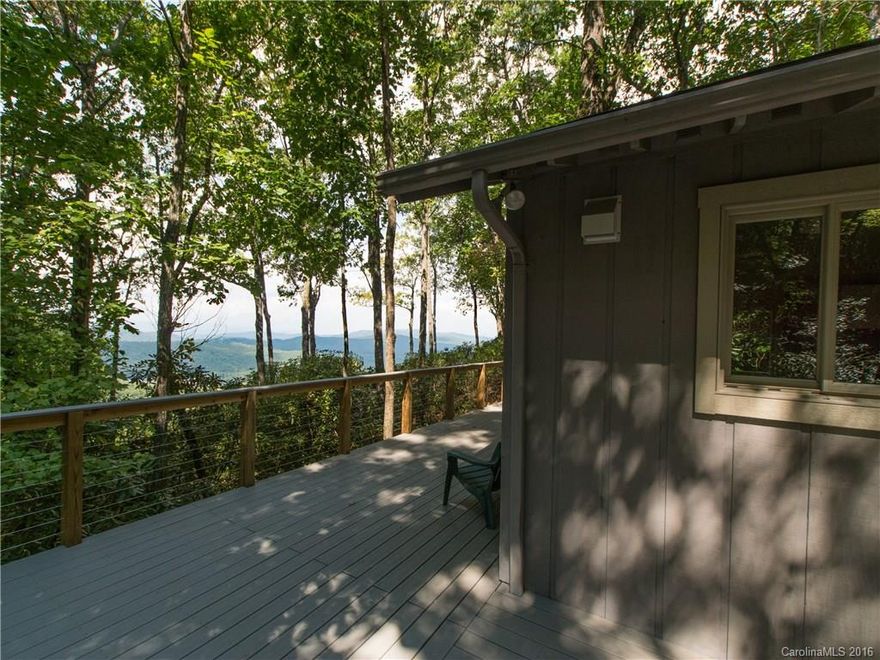 800 ft. up Pinnacle Mtn, tucked in cove on dead end rd. 2 BR, 2 BA cottage alongside stream; long range year round mountain views  3.99 acres/view control.  New composite deck/cable railing, ramp to front.  Interior great room, 7 windows, views on 3 sides.  Wood stove in natural stone fireplace. Kitchen island granite counter, Silestone counter, stainless steel appliances, pantry.  Maple floors throughout.  Bathrooms remodeled, tile or Swanstone shower walls. Jeld-wen windows. Secured storage.