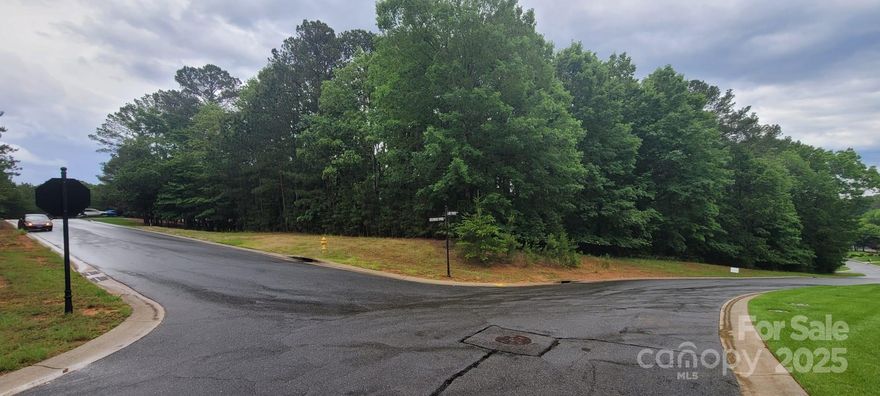 Seize the opportunity to construct your dream residence on this expansive 0.72-acre corner lot, ideally within the prestigious gated community of Reflection Pointe in Belmont, NC. This parcel offers a gently sloping, wooded terrain, ideally suited for a large crawl space, garage, basement, or walk-out basement design. Enjoy the tranquility of a private setting near Lake Wylie, along with the community's resort-style amenities. The clubhouse and the sports fields are just across the street from you. 
Located in historic Belmont, this lot is just minutes from charming downtown shops, parks, and dining options. It also has easy access to Charlotte Douglas International Airport and Uptown Charlotte. This lot is a rare opportunity to build in one of the area’s most sought-after communities.