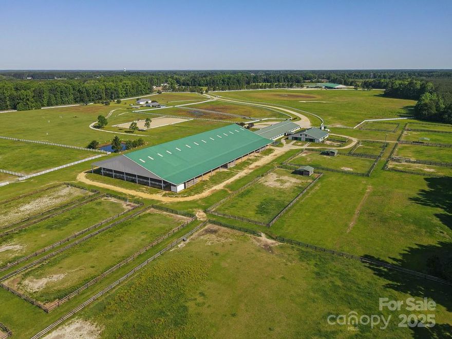 Unlock the potential of this gated 278 acre equestrian facility, designed for both professional & recreational riders alike. Established pastures & turnouts, lined w/pristine white vinyl fencing, create a stunning & functional landscape. The state-of-the-art facility boasts 122 stalls across multiple barns, along w/two covered riding arenas, one indoor arena, one dressage arena, & two outdoor arenas—perfect for training, competitions, & events. The comprehensive infrastructure includes a lounge, office, bathrooms, classrooms, tack rooms, feed rooms, & locker space for boarders, as well as outdoor wash racks for ultimate convenience. A three-bedroom home, detached shop/garage, & ample feed & hay storage complement the property. This breathtaking land is perfectly designed for an event center. Whether for private training, large-scale competitions, or an elite equestrian retreat, this facility offers unparalleled opportunity & versatility. Don’t miss your chance to make this yours!