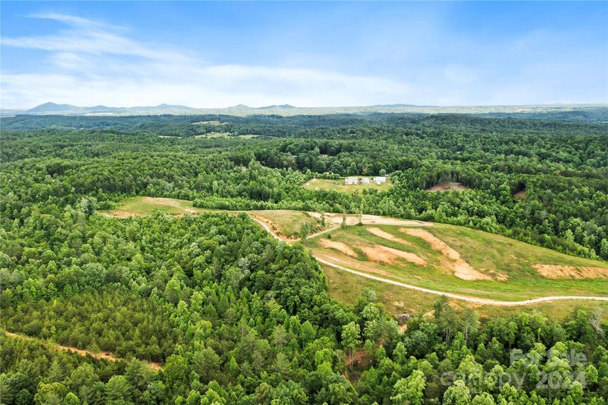 DEVELOPMENT OPPORTUNITY OR YOUR MOUNTAIN DREAM ESTATE! This 118+/- acres borders the upscale community The Coves Mountain River Club with the estimation of approximately 70 lots to use as single-family homes. Sellers have a current 4-bedroom septic permit also you will see in the photos the sellers beautiful home plans that could be yours! Mostly cleared with gorgeous mountain views, pastures, some wooded areas as well as a rushing stream/creek! This acreage has fertile bottom lands, hillsides conducive to blueberries & blackberries. Standing timber includes hardwoods, including black walnuts & planted pine timbers. Two large parcels with many possibilities for residential, farming, homesteading and so much more. Offers hiking, ATV or horseback riding trails. Close to downtown Lenoir, Morganton and approximately 30 minutes to Blowing Rock. Big, beautiful properties like this rarely come available!