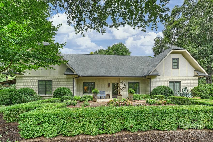 Simply magical… This one of a kind 4 bd 3.5 bath, custom property boasts a sophisticated casual elegance that will transport you to another world. Fine quality & details are evident in the function/design of this serene, pvt oasis. Awaken to swaying palms & lotus blooms. Enjoy a glass of wine in the sunroom while taking in the sights & sounds of nature. Escape to the outdoor dining area w/ fireplace, pizza oven & grilling area. Put upstairs space provides a loft, lg bedroom, bath & bonus room. Notable features include: aluminum clad casement windows, arched entry, custom mouldings, transoms, locally made custom cabinetry, cooks kitchen, quartzite countertops, coffee/small appliance station, detached flex space, pond w/water feature, fenced yard & 2 new HVAC systems. Marble counters/flooring in primary & guest bath. stone & wood flooring in main areas accentuate the natural elements of this home. Walk to Park Rd Shopping Center & Greenway, 15 min to CLT airport. Best location in CLT!