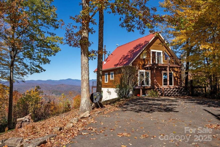 If you are looking for a view house, this is the best one that I have seen come along in a while. Long-range, year-round, long distance, Northwestern views of the Blue Ridge Parkway make this a highly desirable home. This gorgeous log style A-frame house sits proudly on a beautiful knoll nestled in a 5-acre parcel with ultimate, end of the road privacy. It has an electric gate when you enter the property. As you start up the paved drive and see the home on the hill, the view seems to get bigger and bigger as you approach. The everchanging view is breathtaking. The home has over 1400 square feet of decks for you to entertain as you enjoy the views and natural surroundings. Inside on the main level, it boasts a nice kitchen with granite counter tops and stainless appliances. The kitchen is open to the dining area and the living room. You'll love the views from almost every room in the house. It also has plenty of natural light. The main level has 2 bedrooms and a full bath as well. Upstairs there is a luxurious primary suite which has a full bath and a private deck. In the spacious basement, you will like the large den, an office, another bedroom/bonus room, full bath, and the utility/laundry room. Outside you will enjoy a fenced in back yard. In the front, there is a workshop/potting shed. Plenty of square footage, lush surroundings, abundant wildlife, privacy, and unbelievable views make this mountain home a MUST SEE!