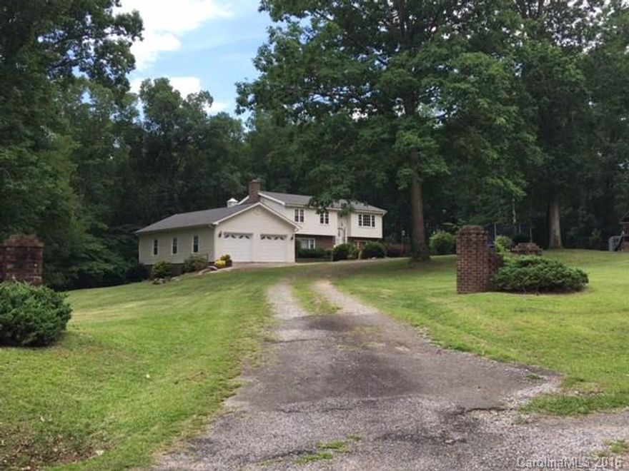 This home has lots to offer! Sits on almost 5 acres, lots of bedrooms, attached garage/workshop.  This is a split bedroom plan with spacious kitchen, living room, great room on lower level with fireplace.  The following is all newer items: all appliances, flooring, windows, paint. Huge deck and patio area.  Large workshop and full bath inside the garage!  A must see!  Age of home is approximate. BA to verify schools.