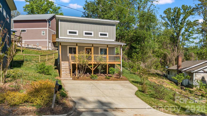 Just minutes from Haywood Road and Carrier Park, this 2022-built 2 bed, 1 bath brings the charm with soaring ceilings, sun-filled spaces, and a covered front porch overlooking a sweet front garden. Inside, a thoughtfully designed layout makes the most of the space, creating an easy, functional flow for everyday living. The partially fenced yard offers just enough outdoor space to enjoy without a ton of upkeep. Enjoy quick access to Haywood Road’s restaurants, bars, breweries, and local shopping, along with Carrier Park’s greenways where you can walk or bike, plus the French Broad River for tubing and kayaking. Walkable, low-maintenance, and close to everything that makes West Asheville great.