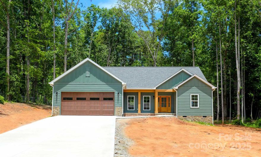 Welcome to your new home—a perfect blend of modern comfort & classic Ranch-style living. Nestled in the serene community of Salem, just minutes from downtown Morganton, this beautifully crafted 1,600 sq ft residence offers 3 bedrooms and 2 bathrooms, with the convenience of single-level living. Step inside to discover a light-filled open floor plan featuring 9-foot ceilings with a vaulted ceiling in the main living area. Expansive windows flood the space with natural light, creating a warm, inviting atmosphere throughout. The living, kitchen, and dining areas flow together seamlessly, making everyday life and entertaining both easy and stylish. The heart of the home is the chef’s kitchen, showcasing light wood cabinets and a gleaming quartz countertop. Tasteful hardwood floors run throughout the home, adding timeless warmth and character to every room. Every detail has been carefully selected to elevate comfort and style. Experience the best of Ranch living with this move-in-ready gem.