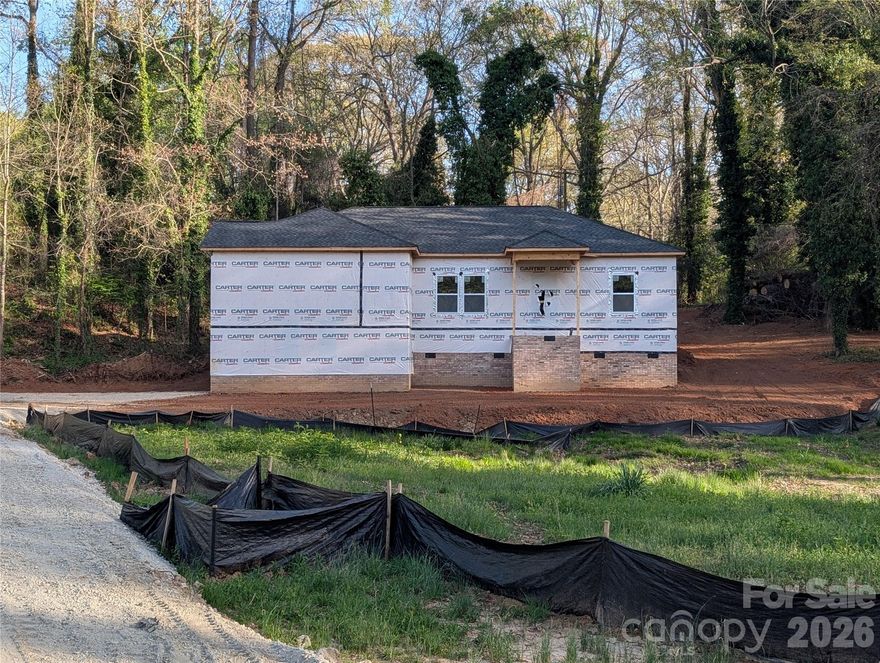 Beautiful 3BR/2BA home on a spacious half-acre lot in the heart of York, SC! Located in an established neighborhood, this home offers an open-concept layout with luxury vinyl plank flooring throughout, perfect for everyday living and entertaining. The kitchen and bathrooms feature granite countertops, white soft-close cabinetry, and quality Moen fixtures. The spacious primary suite includes a private en-suite bath, while both bathrooms are equipped with durable fiberglass shower units for easy maintenance. Enjoy the added privacy of a wooded backyard and a home set back from the street, plus a 10x10 deck, perfect for relaxing and enjoying summer nights. Additional highlights include insulated vinyl windows and garbage disposal. The extended driveway provides plenty of room to park and turn around with ease. This move-in ready home combines comfort, functionality, and privacy, all in a convenient York location!