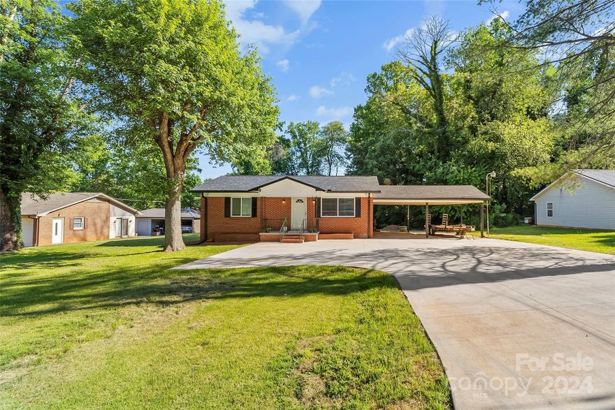 Check out 2275 19th Ave. NE, Hickory NC! This home is ready for summer and entertainment. This property is conveniently located near coffee shops, shopping centers, and major highways, making this an ideal choice for those seeking both comfort and convenience. This home has a double carport and a large parking pad for many vehicles. New roof. New air/mini split downstairs. Current septic permit is for 2 bedrooms, however, city sewer hookup is available (fee applies) and the 2 rooms in the basement to make this a 4 bedroom. This home is turnkey.