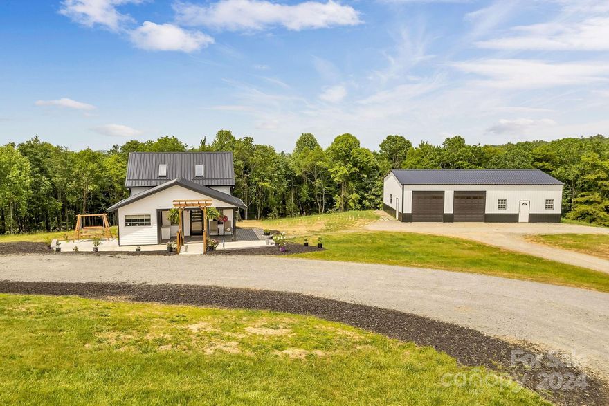 Welcome to your mountain oasis! Imagine waking and enjoying your morning coffee on the porch as you soak in the natural beauty that surrounds you. Nestled on four acres of pristine land, this stunning one-bedroom, one-bathroom home offers the ultimate escape from the hustle & bustle of city life. Step inside to discover an open design with luxury vinyl plank flooring & stainless steel appliances that grace the recently updated interior. Every detail has been meticulously crafted to create a comfortable & inviting living space. Go up the winding staircase to the loft that hosts the bedroom & a walkway looking over the downstairs. Outside, you'll find an oversized detached 2 car garage, complete with a workshop for tinkering on your latest projects or storage & electrical connections perfect to finish for separate living quarters. Located just a short distance from the Blue Ridge Parkway, New River, Little River, & Stone Mountain, outdoor adventures await right at your doorstep.