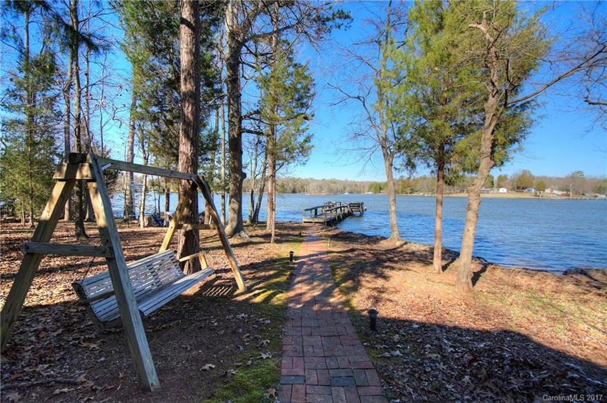 Nostalgic waterfront cottage in the heart of Lake Wylie offering a wide open channel view. Outdoor features include level lot, beach areas, deep water, 200' +/- shoreline, floating dock w/ seating area and on-shore boathouse. Detached "little house" makes a great She Shed/Man Cave-great for office, hobby, exercise, etc. 3BR/2BA home w/ open floor plan, spacious kitchen, lakeside sunroom. Enjoy as is or update when ready. Clover schools, low SC taxes, convenient to restaurants, shopping, airport.