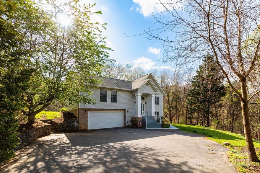 This split-level home has all the charm and updates you’ve been looking for. Inside, you’ll find beautiful hardwood floors, vaulted ceilings, and tons of natural light. The kitchen is a dream for anyone who loves to cook, with plenty of space and style for baking or entertaining. Step out back and enjoy the peaceful setting from the porch—perfect for relaxing while you take in the view of the lovely, private yard. Downstairs, there’s a bonus family room that gives you extra space to spread out, work, or relax. The home has been very well cared for and includes great upgrades like a tankless water heater, gas furnace, and a spacious two-car garage. It’s tucked away in a quiet spot, but you're just minutes from downtown Mars Hill, or 20 minutes to Asheville! If you’re looking for a move-in ready home with space, comfort, and some serious charm—this is it!