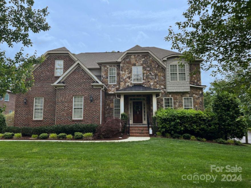 This stunning James Custom Home on a quiet cul-de-sac street boasts exquisite brick and stone craftsmanship. Enjoy the open floor plan, gleaming hardwood floors, and a cozy stone fireplace in the great room. The kitchen dazzles with granite countertops with a tile backsplash, a spacious island, stainless steel appliances, updated lighting (2023) and a double door pantry. A main-level guest suite adds convenience, while the upper level features a luxurious primary suite with a spa-like bath and expansive closet. Generously sized secondary bedrooms and a versatile bonus room offer ample space. Entertain on the screened porch or paver patio overlooking the large lush fenced backyard. Features include oversized Garage with storage, architectural roof - 2021, Rheem HVAC with 3 zones - 2022, New Neutral Carpet - October 2022, updated lighting in dining and breakfast rooms-2023. Plus, enjoy neighborhood amenities like a pool, clubhouse, and playground. Don't miss out on this peaceful retreat!