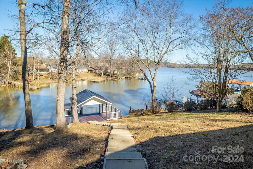 Lake Lookout – Summer Fun Awaits – Nestled off Carpenter’s Cove, enjoy the beauty of simplistic lake front living with quiet, water frontage and stunning main channel views. Whether you are sipping coffee on the back deck or basking in the sun on the floating dock, this cozy home offers the perfect retreat. With open concept living and dining, natural light radiates through the lakefront windows,full bath and flex spaces with laundry offers ample storage. Entertain or relax with ease on the spacious covered deck by the lake and experience the tranquility Lake Lookout offers. Centrally located minutes from 1-40 and Hwy 16, convenience is key.