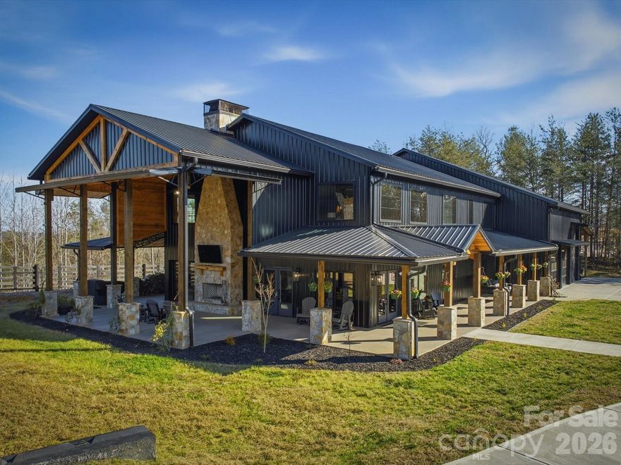 Nestled on 12.20 acres, this spectacular Barndominium blends rugged outdoor appeal with refined, contemporary design just minutes from Lake James—about 1500 feet away with multiple access points—and the Fonta Flora Trail for biking and hiking nearby. The area is a haven for outdoor enthusiasts, with North Carolina’s largest state park (South Mountain) and nearly 500,000 acres of Pisgah National Forest, plus the Blue Ridge Parkway, all within reach, about 1.5 hours to Charlotte Douglas International Airport and roughly an hour to ski lodges. Inside, this 3-bedroom, 2.5-bath home is “over-the-top” in both extras and craftsmanship, featuring a standing-seam metal roof accents, a dramatic 20-foot double rock fireplace (gas in the interior, wood-burning exterior), and cathedral ceilings with exposed wood beams and a giant ceiling fan. The front hall reveals T&G burnt wood walls and a maple-tree log used as a post, while oversized windows and a partially open-to-outdoors entertainment area—with a front-facing mini garage door—invite the outdoors in. A state-of-the-art kitchen showcases rustic concrete countertops, custom cabinetry, a center island, and high-end appliances, complemented by ultra-efficient multi-zone HVAC. The property includes about 2,400 square feet of garage space with oversized doors, eliminating off-site storage and offering ample room for prized collections. A fenced, gated entrance and concrete driveway provide secure, convenient access, and the planned pool area next to the entertaining space hints at even more lifestyle possibilities. This is truly a one-of-a-kind home that will leave a lasting impression; prequalification or proof of funds is required to schedule a showing.