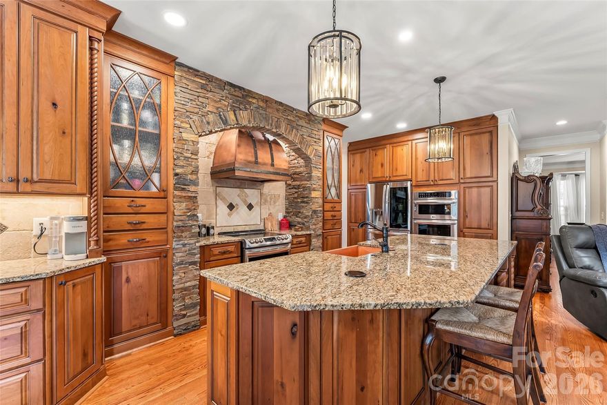 Tucked away on a quiet cul-de-sac, this gorgeous 5 bedroom + bonus room, 3 car garage home offers the perfect blend of elegance, functionality, and lifestyle. Whether you're looking for multi-generational living or love to entertain, this home has it all. The main level features beautiful hardwood floors, a guest bedroom that's ideal for visitors or a private home office and a showstopping living room with a soaring two story ceiling that's light and bright. A dramatic floor-to-ceiling stacked stone fireplace is flanked by custom, timeless built in bookcases that add warmth and sophistication to the space. The fully remodeled kitchen is a standout, designed to impress and entertain, featuring high-end finishes, a wall oven and microwave plus another double oven stove, a striking copper hood, cabinets with rollouts and a seamless flow into the main living spaces and to the rear deck. This open layout is perfect for entertaining. Downstairs, the fully finished basement offers tall ceilings and incredible flexibility with a complete apartment setup, including a bedroom, full bath, living room with fireplace and full kitchen-a space for true multi-generational living or extended guest stays.  The stairs to this level have a chair lift for extra easy access. Step outside to your private backyard retreat, where a beautifully designed paver patio with built in seating area and fire pit create the perfect ambiance for relaxing or hosting. An additional covered pavilion area is the perfect place for soaking in the wonderful Carolina weather-making outdoor entertaining effortless, all set within a serene, tree lined yard that offers both privacy and charm. Upstairs you'll find an open hall overlooking the two-story living room, a primary retreat overlooking the lush backyard, two additional guest bedrooms plus a huge bonus room.  If storage is what you desire, this home has an enormous unfinished storage room in the lower level, plus lots of cabinetry and closet space.  HVAC replaced in 2018/2021 and New Hot Water Heater Est. 2022. Conveniently locating in Mooresville off of Brawley School Rd, this home is just minutes from everyday essentials, dining, I-77, Costco, Publix. This home delivers both luxury and convenience in one of Mooresville's most desirable areas. LKN Public Boat Access Nearby. 32 miles to CLT Airport. A rare opportunity to own a home that truly has it all. You'll love living here!  24 hours notice to show.