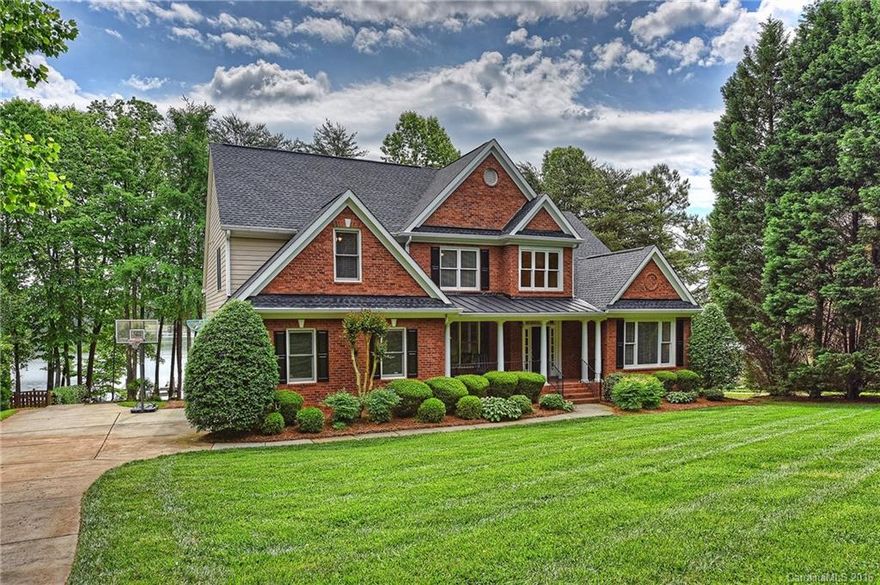Enjoy lake living at its finest in this incredible waterfront retreat. The home presents a sandy beach, pier with private boatslip, & an abundance of outdoor entertaining space.  The main level has a desirable open floorplan including the Mstr Bd & a Guest Ste. The considerable Great Rm has a grand feel with a soaring two story ceiling & built-ins. Many recent updates including new hardwood floors, new kitchen appliances, & new carpet throughout. All bedrooms provide access to a private bath.