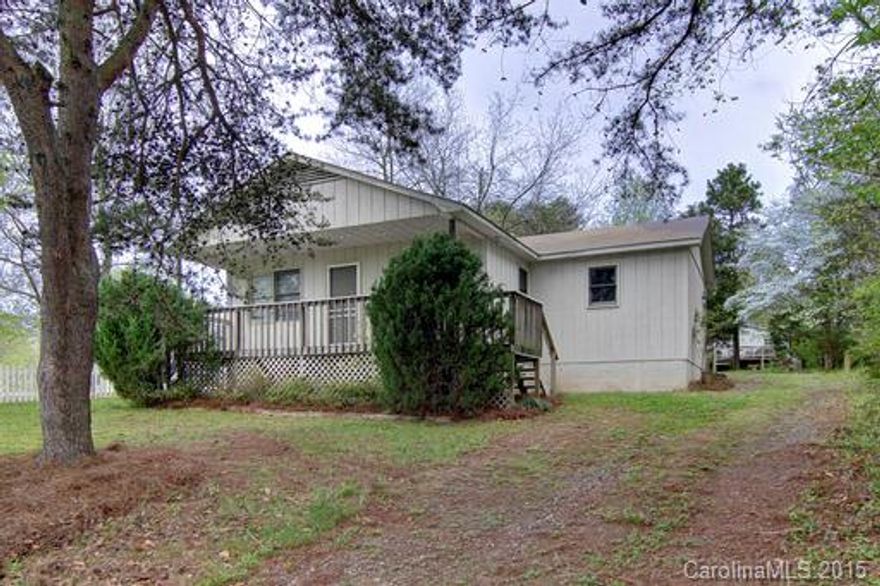 Quaint home in ideal Mooresville location. Rocking chair front porch, back patio, plenty of parking, back load garage and extra storage/shop building equipped with window ac unit. Inside home you'll find nice size kitchen and living rooms. Easy access to laundry and kitchen from garage.