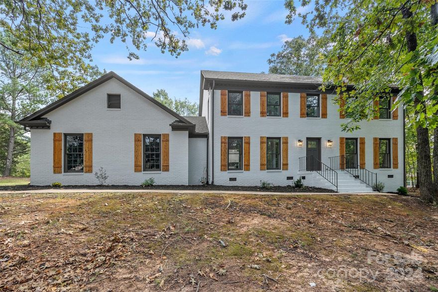 Welcome Home to your new Rock Hill Oasis! This stately full brick home has been completely updated and is ready for new owners. The fully fenced 0.63 acre lot features an in-ground pool, fresh landscaping, and a large deck nestled amongst mature trees.  Step inside to find every detail is tastefully designed - from the durable LVP flooring, modern light fixtures, brand new tile, cabinetry, & more.  The primary suite features 2 large walk-in closets with custom built-ins & a gorgeous ensuite bathroom to unwind in style.  You don't want to miss this one!