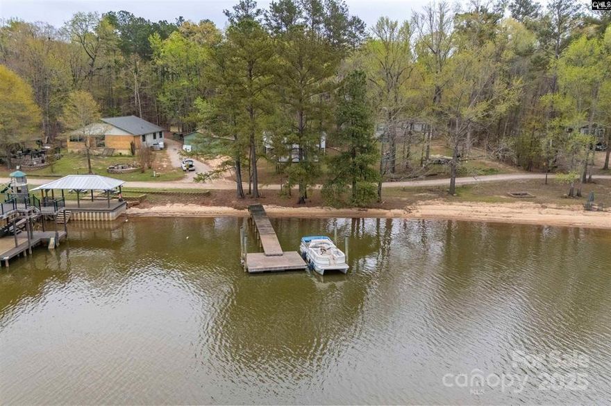 Check out this adorable 3 bedroom 2 bath lake home with private pier, sandy beach front and a golf cart ride away to Beaver Creek Marina, restaurants and entertainment. Make this your part timer or full time residence and enjoy Lake Wateree this summer! Property runs to center of Beaver Creek as noted on Deed. Disclaimer:  CMLS has not reviewed and, therefore, does not endorse vendors who may appear in listings.