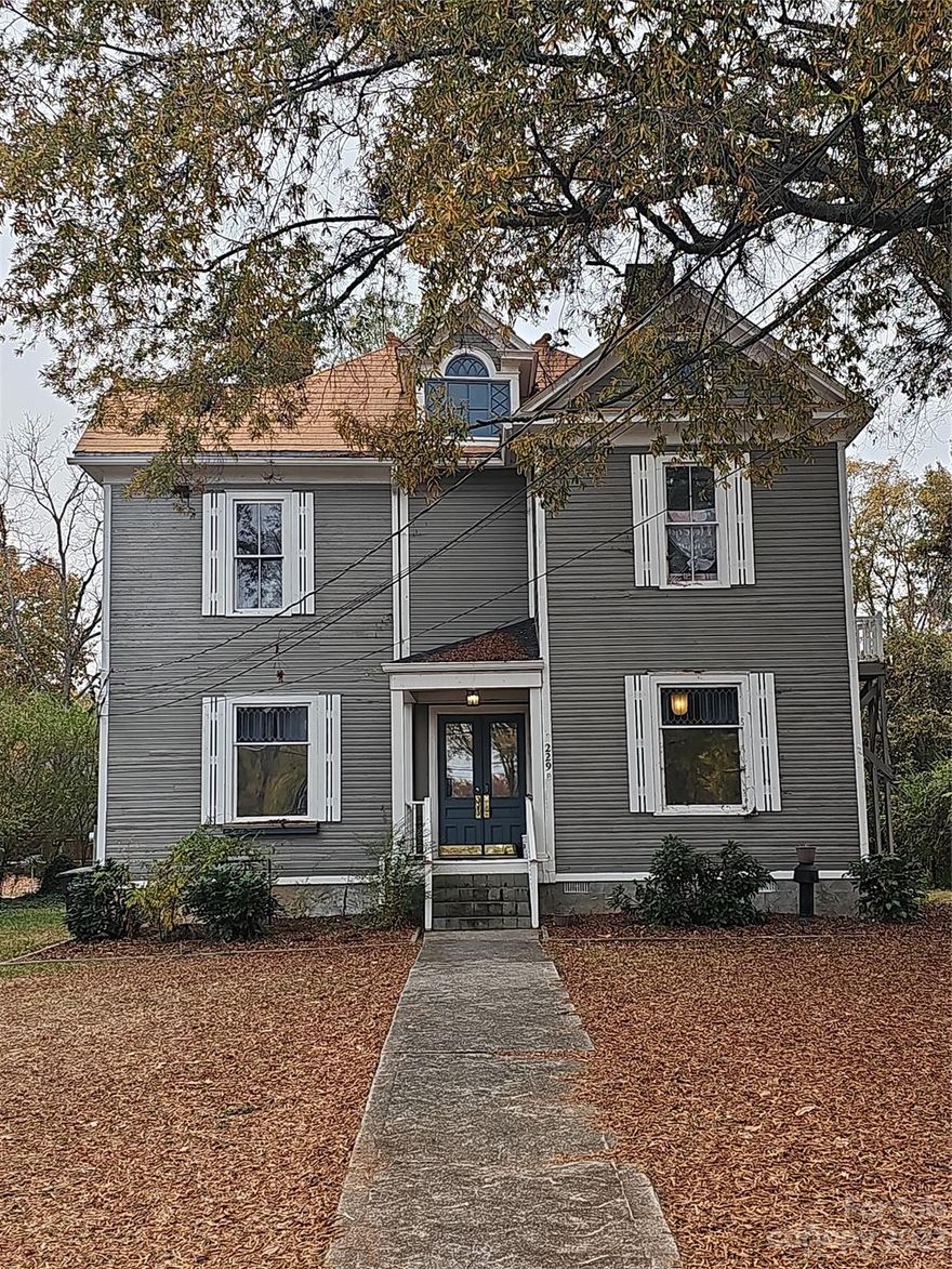 Historic home on large lot in Statesville! This 4 bedroom 2.5 bath home was renovated by the previous owner keeping it's historic charm while introducing several modern features.  Main floor large living area open to the kitchen is perfect for entertaining. Primary bedroom on main.  Upper floor with 3 bedrooms and bonus room leading to a small deck.