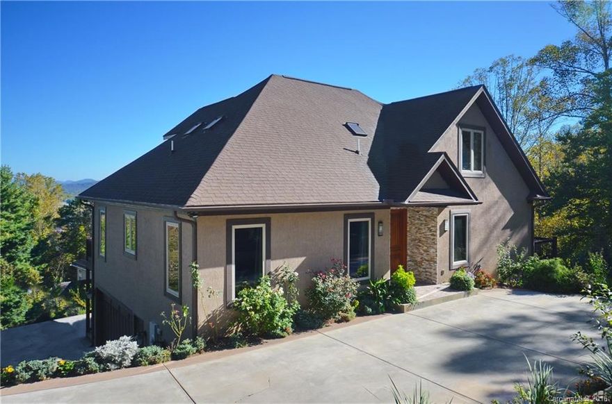 Executive home in upscale neighborhood, features gourmet kitchen w/granite, large master on main w/large walk in closet, hardwood & ceramic throughout, wood burning fireplace in high ceiling great room, open floor plan, office, lower level in-law suite w/2nd kitchen & laundry room, separate entrance. Very lowest level day light basement could be studio or large play room. Multi-zone heating system. Asheville School 5 miles away. Only minutes to downtown Asheville. Magnificent view. Check it out!