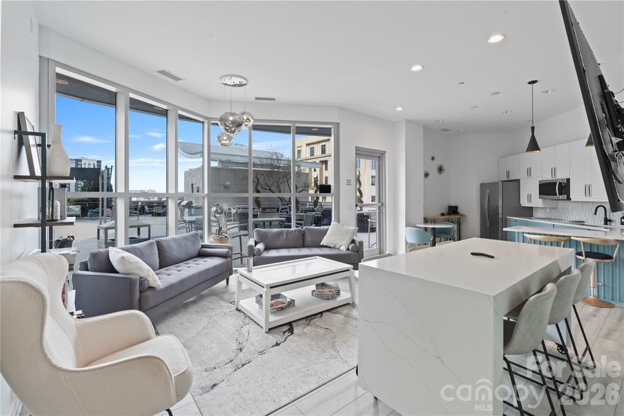 Experience elevated Uptown living at Trademark Condominium from this stylish 21st-floor contemporary condo featuring sweeping skyline views and stunning sunset panoramas. Floor-to-ceiling windows fill the open-concept living space with natural light, while the modern kitchen offers a granite island, upgraded lighting, and seamless flow ideal for both everyday living and entertaining. Thoughtfully updated and move-in ready with designer finishes throughout.

Enjoy unbeatable walkability to Bank of America Stadium, Spectrum Center, Romare Bearden Park, premier dining, nightlife, and the light rail, with convenient access to I-77.

Trademark residents enjoy exceptional amenities including a sky-level pool deck with grills and fire pit, fitness center, renovated resident lounge, secure access, and covered parking—offering the perfect blend of luxury, convenience, and urban lifestyle in the heart of Uptown Charlotte.