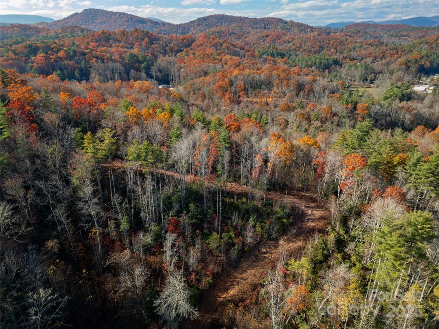 With proposed lots outlined, roads in place, and underground power installed, bring your high-end residential and/or mixed use development to life on this +/- 40 acre tract! A luxury RV resort, scenic mountain subdivision, and/or "live, work, play" neighborhood would thrive in this area of beautiful Lake Toxaway, North Carolina. Ideally situated just 12 miles from downtown Brevard and 28 miles from the heart of Cashiers, this rare parcel offers an exceptional blend of convenience and seclusion. The property features county-approved build sites, an easily navigable road system, underground utilities, and multiple vantage points showcasing breathtaking long-range mountain views. Also, take advantage of the commercial potential with +/-1500 feet of prime frontage on Hwy-64 with multiple access points for driveways. With a gentle topography and NO RESTRICTIONS, this property could be utilized for almost anything you could imagine. Inquire today to book your private showing! Bonus: additional, creekside acreage is also available in the event more acreage is desired, and PARTIAL OWNER FINANCING IS AVAILABLE.