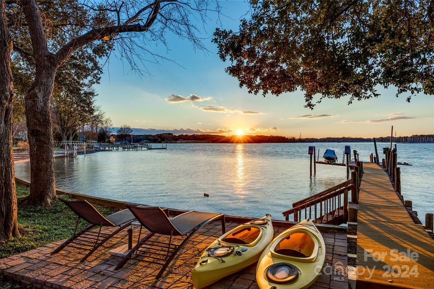 **Renovations complete! Come see the changes! New LVP throughout upstairs and basement, wallpaper removed, fresh paint, ceiling fans and more!**

Welcome to this lovely waterfront home situated on a peninsula with panoramic views of Lake Norman. This setting provides a sense of tranquility and privacy that is hard to find elsewhere. Every room offers a glimpse of the surrounding tranquil waters. This home has been fully updated while retaining some of the original accents, exuding a perfect blend of modern comfort and timeless charm. The main level floor plan was thoughtfully redesigned to optimize the breathtaking views of the lake, as well as, transform the home into a sanctuary of light and space. 

This home boasts 5 spacious bedrooms, 3.5 baths, 2 separate living areas, sunroom, and more! 

Dock sold AS/IS. City sewer available for tap fee/grinder needed.