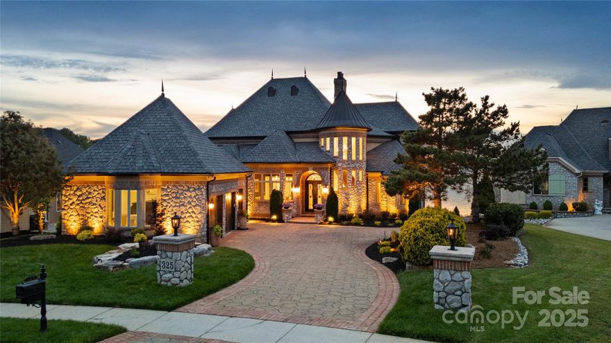 Experience unparalleled luxury in this breathtaking custom waterfront estate on Lake Wylie, nestled in the exclusive gated community of Joslin Pointe. Showcasing rare panoramic main channel views, this European-inspired brick and stone masterpiece offers over-the-top elegance w/ a soaring two-story great room, a remodeled chef’s kitchen featuring Viking appliances, custom cabinetry, quartz countertops, and upscale finishes throughout. The main-level primary suite features porch access w/ water views and a marble spa bath w/ dual vanities, soaking tub, walk-in shower, and dual custom closets. Entertain on three levels w/ endless amenities including, wet bar, climate-controlled wine cellar, full basement bar, movie theater, and billiard room. Outside, relax or entertain with picturesque sunset views, gas firepit, outdoor kitchen, Trex Dock with covered boat slip w/ remote controlled 9,000lb lift, 2 wave runner lifts and sun-bathing area. This estate defines luxury lake lifestyle living!