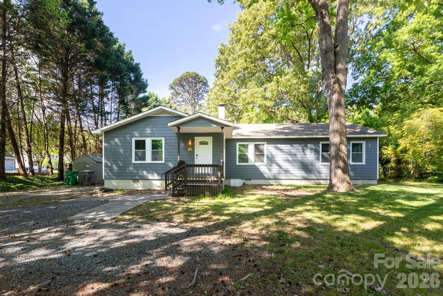 Welcome to 10623 Rozzelles Ferry Rd, a wonderfully remodeled ranch style home full of charm! Unlike most homes built in the 50's the living area has an expansive and open floor plan, and ample storage space. Step inside to find beautiful hardwood floors throughout, providing warmth and character to every room. The centerpiece of the living space is a working wood burning stove, creating a cozy atmosphere for gatherings or quiet evenings. The modern kitchen features leather granite counter tops, a modern farmhouse sink and faucet, dishwasher, and a large refrigerator. There is also a working wood burning fire place in the original primary suite that makes the space so inviting. There are multiple closets throughout, a butlers pantry and massive laundry area and flex space! There is also a large attic for additional storage. Outside, you'll find a fenced backyard perfect for outdoor activities like gardening or BBQing as well as a separate storage shed for your organizational needs. I can't forget to mention its convenient location! Close to I-485 and I-277, with just a short 15-minute drive to Uptown. No HOA and all the appliances convey. Please note that prior listings state the home uses a septic tank. The current owner has tapped into the city sewer and the septic tank has been removed.