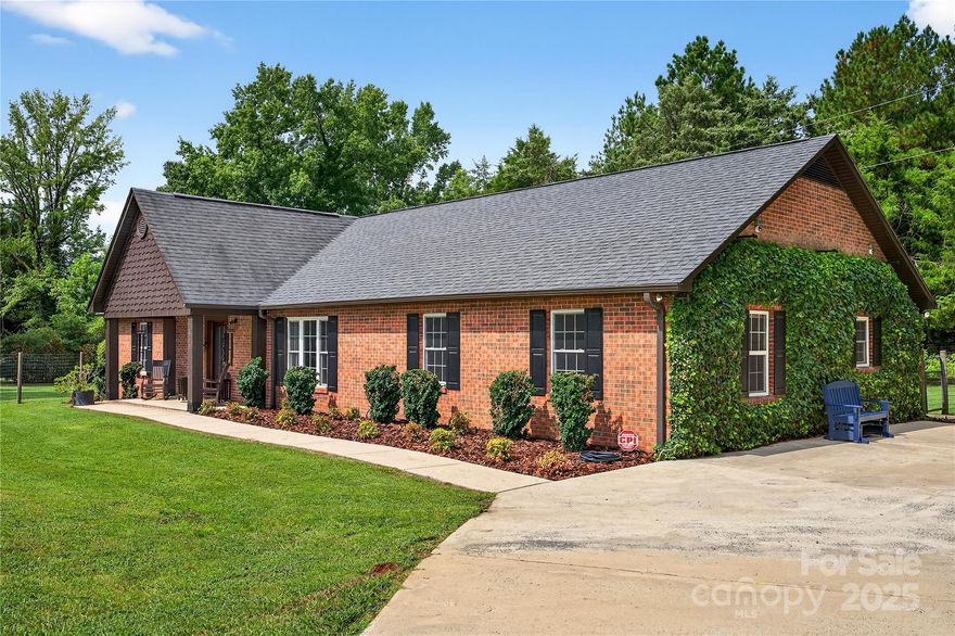 Beautifully updated all-brick ranch home with a spacious, open-concept design! Enjoy a stunning chef’s kitchen featuring a large island, abundant counter space, and tons of natural light, creating an airy and inviting feel throughout. Laminate wood floors flow through most of the home. This homeowner thought of it all including landscape lighting, tankless water heater, water spigot near chicken coop and more.  The extra-large primary suite offers a spa-like retreat with a walk-in steam shower. Split bedroom plan provides privacy and flexibility. Step outside to a massive fenced yard complete with a hot tub, two wired workshops—one with a covered patio—and a deluxe chicken “mansion” coop for fresh eggs. A rare find with space, comfort, and charm!