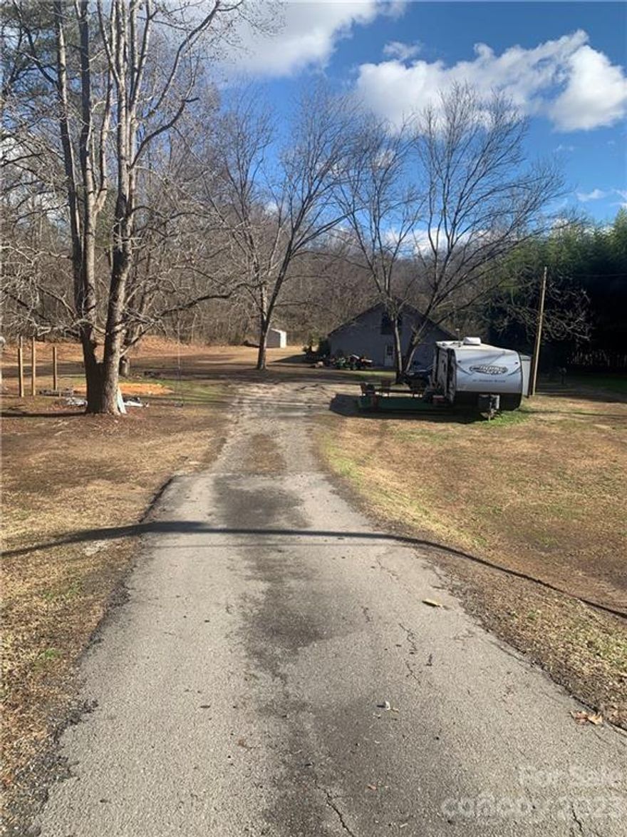 5.41 acres in great Clover location! Land does include a 48x37 Storage Barn/Shed which is wired & plumbed. There is also a loft in the barn/shed on the 2nd floor. however, no stairs to go up. Land is level and beside a creek. Land does have 2-1000gal Septic tanks but no well. Land is zoned "RSC-30" but presently no home is on property. Property shows in a flood zone. Seller states he has never seen the land flood since he has owned it. All Personal Items in Storage barn/shed NOT included. Seller will remove personal items along with small shed in back yard. Shed, Septic Tanks, HVAC, Electric sold AS IS, but no known issues. Land could be used for many things: residential home, farming, possibly RV Park, etc. PLEASE DO NOT DISTURB the Tenant living on property in the Camper.