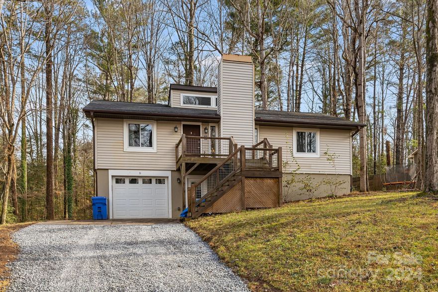 Nestled perfectly between Downtown Asheville and Hendersonville, this thoughtfully remodeled four-bedroom, three-bathroom home offers the best of mountain living outside of HOA fees. Don't miss the flex space in the basement that could function as an office or extra climate controlled storage! The heart of the home features a stunning fireplace, creating a cozy atmosphere for family gatherings. Step outside to enjoy starlit evenings around the custom river stone fire pit. Fully renovated in 2018, this residence combines modern amenities with classic charm. Conveniently located near Airport Road, this property provides easy access to local attractions while maintaining its peaceful setting.