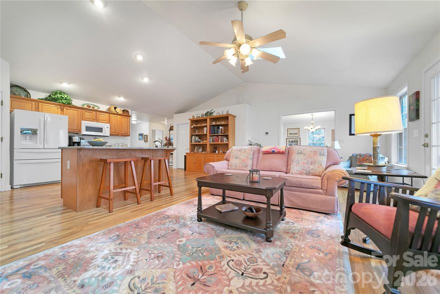 Drive up to your new home, on the level cobblestone driveway surrounded by native plants and mature woods, to this beautifully maintained, peaceful retreat tucked away at the end of a cul-de-sac on a rare double lot in Connestee Falls. Built in 2002 and lovingly cared for by its original owners, this home offers a gracious, welcoming layout ideal for both entertaining and quiet evenings by the fireplace with your favorite book. The spacious dining room is filled with natural light and overlooks acres of serene common-area forest, creating a lovely backdrop for everyday meals or special gatherings. Step outside to enjoy the recently upgraded outdoor living spaces, featuring all-new high-end composite decking and an open deck just off the screened porch. Inside, the remodeled kitchen shines with beautiful granite countertops, an added coffee bar, additional cabinetry, and matching new cabinets in the laundry room. Bathrooms have also been updated with Silas stone vanity tops. The basement offers an insulated workshop area, an exterior door leading to a level graveled space beneath the screened porch, and an easily accessible crawlspace providing ample storage.