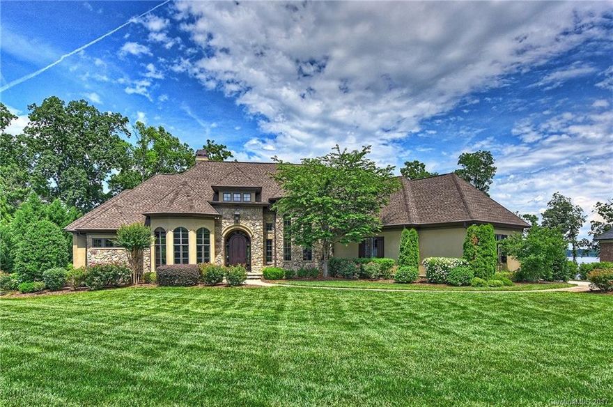 Location is everything on this Beautiful Waterfront Ranch Home w/ full walkout lake level including Private Deeded Boat Dock w/hoist & pier, walk right into the water from your own beach area, Set on Screened Porch and watch the Days activities or the Sun go down, Main level lives like a Ranch w/Chefs Kitchen, Master Suite, Office/Study, Laundry, Dinning Room & Great room. Take elevator down to the Billiard Room w/Pub & Kitchen, Lg Family Rm & Guest Rooms. Huge Workshop Area & plenty of storage