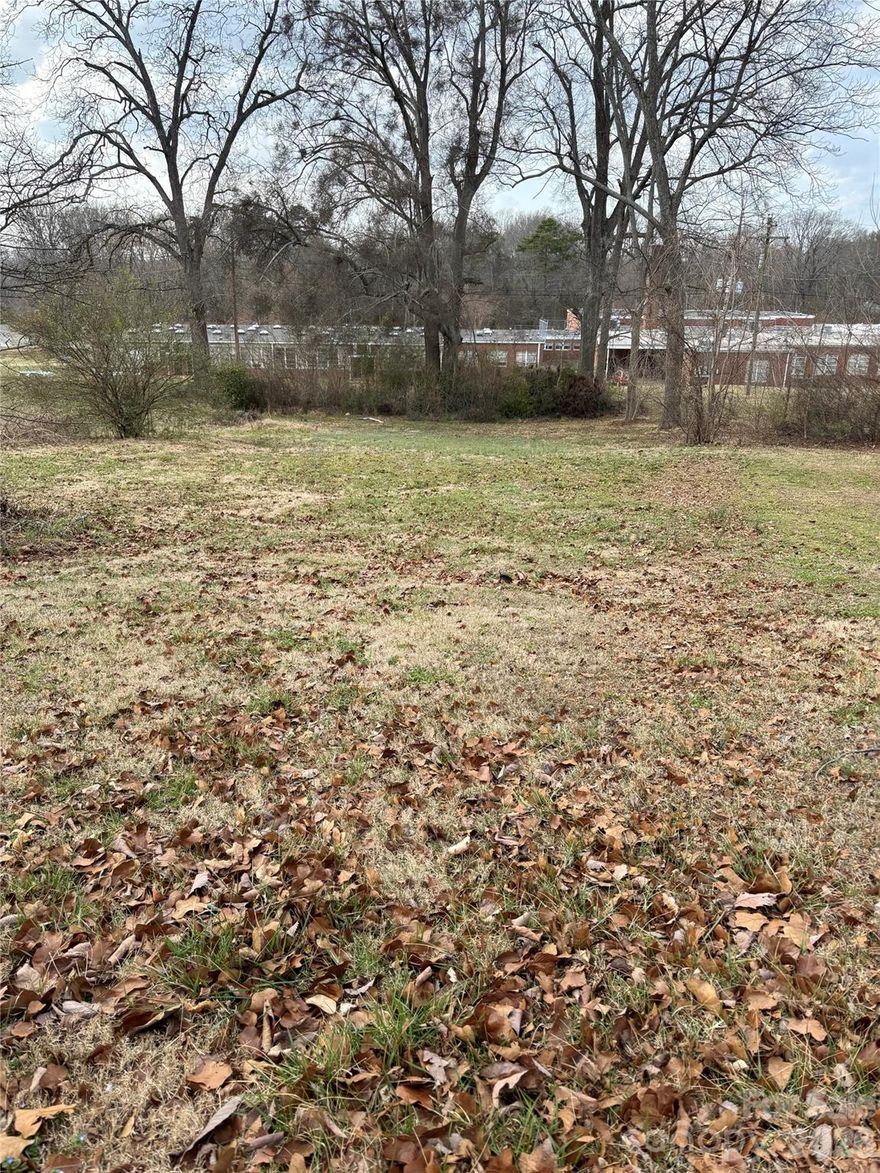 Lot for sale in the city limits of Kings Mountain! Are you looking to build your next home in an established neighborhood with sidewalks? This lot may be JUST WHAT YOU NEED for your new construction. 
There was a house on this lot many years ago and the concrete steps to that old home are still in place.
The lot is approximaately .32 of an acre and backs up to North Elementary School.
The house next door has electricity, water, sewer, trash pickup and natural gas with the City of Kings Mountain, which is conveniently on one bill each month. 
Per Nate, with the City of Kings Mountain, the setback requirements are:  25 ft at the front, 20 ft at the rear and 10 ft  on each side of the lot.
This location is just 28 miles to the Charlotte Douglas A tyort, 15 minutes to the South Carolina state line and within minutess of grocery stores, parks and all the ammedities that Kings Mountain has to offer.
Come see it today!!  (GPS directions: use 817 No. Piedmont Ave., Kings Mountain)
BUYER AGENTS WELCOME!