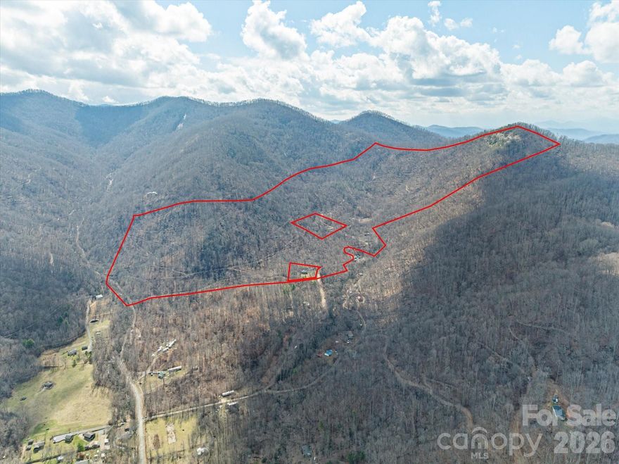 Excellent large tract of land with so much opportunity in Buncombe County. Priced under $5K per acre, you will not find a better value. The property is approximately a 30 minute drive to Asheville, NC and even less to the nearby towns of Barnardsville, Mars Hill and Weaverville, NC. The property features include a stone structure that could be the beginning of a really amazing dwelling with a pond and views already in place. There are multiple access points onto the property either from Wild Mountain Lane or Haw Branch Road. The views from many locations within property are stunning. The highest peak on the property "Haw Knob" has an elevation over 3900 ft. Several water sources (springs) originate on the property and form small creeks and ponds. The largest creek "Haw Creek" is located on the eastern boundary of the property. Many logging roads and trails meander through the property. The property is currently in a forestry management plan.  The property is also listed as Land/ Acreage, MLS #4350431