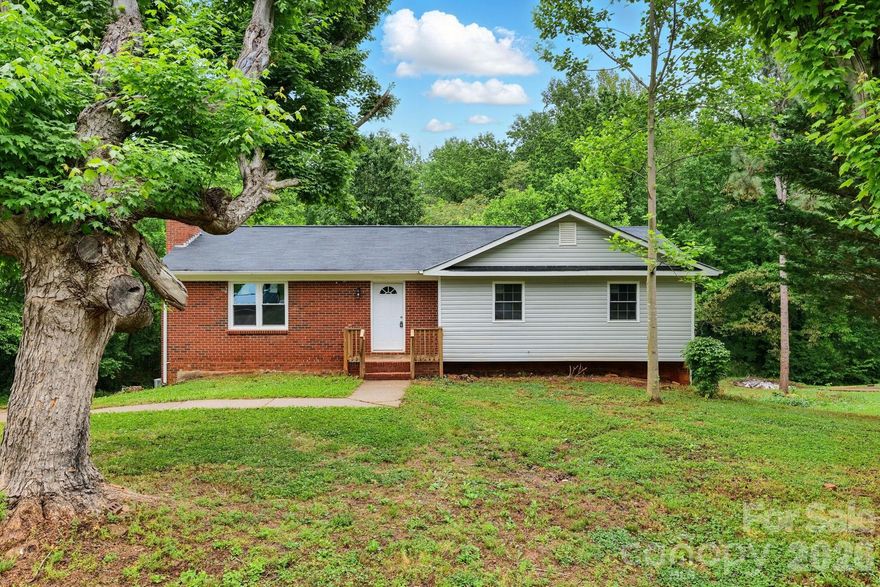 Move-in ready renovated brick ranch with finished walk-out basement and flexible living space on a quiet, tree-lined street.

This updated 3BR/3BA home features an open-concept layout, white shaker cabinets, granite countertops, stainless steel appliances, and a spacious kitchen island. Durable LVP flooring throughout — no carpet.

The fully finished walk-out basement adds valuable square footage with a large rec room, full bathroom, laundry area, and flex room with walk-in closet — perfect for a guest suite, home office, bonus room, or multi-generational living.

Enjoy outdoor living on the private back deck overlooking mature trees, creating a peaceful, treehouse-like setting. A cozy wood-burning fireplace adds warmth and character to the main living space.

Conveniently located near Lake Norman State Park, Fort Dobbs, downtown Statesville shops & dining, and the Carolina Balloon Fest, this home offers the perfect blend of quiet neighborhood living with easy access to local attractions and outdoor recreation.

Renovated. Finished basement. Flexible layout. Private setting. Move-in ready.