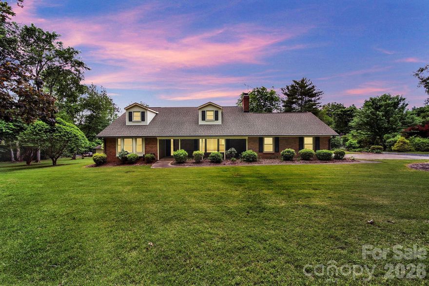Spacious brick 1.5-story home with 2857 sq ft situated on 5.12 acres, featuring secondary living quarters and almost 1600 sq ft of workshop/outbuilding space. Located  in the growing Caldwell / Tom Query corridor with a Charlotte address in Cabarrus County. This 4-bedroom, 4-bath property offers a unique blend of space, functionality, and opportunity.   A welcoming front porch leads into a comfortable living room featuring a fireplace. and built-ins. The kitchen includes a stainless steel wall oven, convection microwave, dishwasher and granite countertops. Large second living quarters provide excellent flexibility for multi-generational living or guest space. Most of the acreage has already been cleared, offering endless possibilities for outdoor living, recreation, or future expansion. Property is currently on well and septic, with water and sewer available. Conveniently located near shopping, dining, and commuter routes while still offering privacy and room to spread out. Property being sold “As Is.”