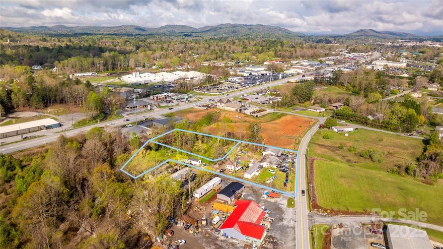 Presenting a versatile commercial investment opportunity at 1611 Old Spartanburg Road and 48 Heavenly Valley Lane in Hendersonville, NC. This combined 1.66-acre property encompasses two parcels with dual addresses, offering a mix of retail and residential income potential. The 1611 Old Spartanburg Road parcel features a 1,360-square-foot building currently utilized as an automotive repair shop and six mobile home pads. This site is well-suited for various commercial uses and benefits from its strategic location along a high-traffic corridor, providing excellent visibility and accessibility. Adjacent to this is 48 Heavenly Valley Lane, a vacant commercial lot on approximately 0.71 acres. This setup offers steady rental income and the potential for future development or expansion. Situated just minutes from downtown Hendersonville and in close proximity to Spartanburg Highway, this property offers a unique blend of commercial and residential opportunities.