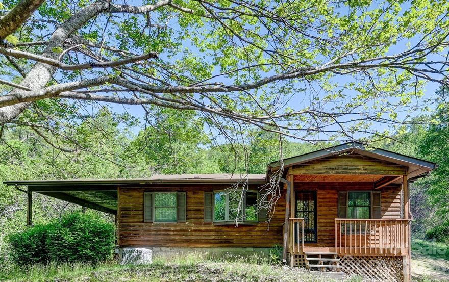 This Home Sits on 2.33 Acres close to 'All Things South Asheville'. It is nearly move-in ready; just add kitchen appliances. The possibilities are endless; First Time Homebuyers, Downsizers, or as a Short or Long Term Rental Property. The 'Very Large Lot' sets this property apart from Anything Else You'll Find in This price range. There are 3 different outdoor covered areas to enjoy the Peace & Solitude. Dine or Lounge on the Large Covered Deck off of the living room, Swing on the Covered Front Porch Swing, or enjoy the Backyard View from the Covered Back Patio. The floorplan is 'Open Concept' Living room, Dining area, and Kitchen; with a nice Bay Window in the Living area for growing plants indoors year round. A nice big Laundry Room is located right off of the Kitchen with Plenty of Storage area. There are 2 bedrooms and one full bath; with everything on one level. There is a tall crawlspace with room for additional storage under the home. An abundance of outdoor space for gardening, pets or just enjoying nature, with an outbuilding for your lawn and garden supplies. With 2.33 acres it is possible you may even be able to add another home; but this would need to be confirmed by buyers.