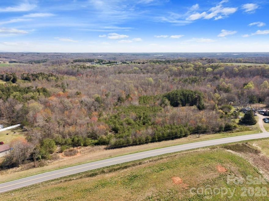 Bring your vision to life and build your dream-home on this huge 16.50 acre property! Two streams, rolling hills, and your own private wooded forest invite deer and other wildlife to explore your new back yard. This will make an excellent, large, private estate lot for a custom single family home. Site-built, modular/pre-fab, and mobile homes are all welcome in this zoning. This beautiful 16.50 acre property has access to county water, electricity, and comes with a passing perc test good for a standard septic system. Abundant soils were found all through the property suitable for a 5-bedroom home, or probably even more if desired! The lot will be subdivided off from the parent parcel (hence the price drop) which is expected to be recorded by the end of April 2026. Located just 1 hour from Charlotte, 22 minutes from Statesville, 34 minutes from Winston-Salem, and 1 hour from Greensboro, this property offers a peaceful rural setting with easy access to major markets.