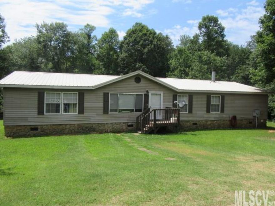 PRIVATE 3BD 2BA Doublewide with 0.88 acre lot and a small stream bordering the property!!! Metal roof, HVAC only a few years old, insulated windows, den with fireplace ,living room, dining area,kitchen with custom cabinets and breakfast room ,all appliances remaining even washer/dryer!! Master bedroom with en suite bath that has a new Bath Fitter shower w/lifetime warranty, solar shades throughout the home , updated lighting ,walk in closets and almost 1800 sq.ft.Outbuilding and nice level lot .priced at $79,777