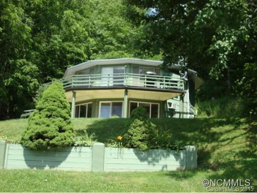 You CAN have it all.. Mtn Views, stream and on the golf course.  This home has 2 living quarters, each have a great room, kitchen, 2 bedrooms and 1 1/2 baths on each level.  Enjoy the sounds of the stream.  The lower level has a studio that can be used for a office, den or craft room.  Lots of decking , lots of parking with a double carport.  A must see!!