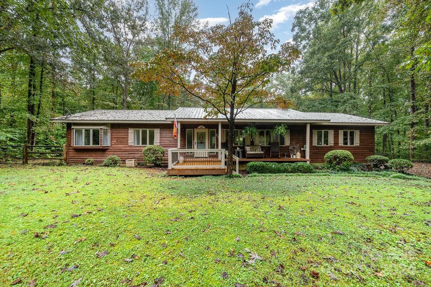 Looking for privacy in beautiful horse & farm country? Check out this mini-farm on 5 acres, 3 horse barn w/ tack room & pasture, 2-3 car detached garage workshop, & a tiny house for fun or extra income! The main home is a 3 bedroom/2 bath rustic ranch with metal roof & unmatched privacy. Primary bedroom flooring is brand new. Come see your own level fenced backyard, covered porch with tiki bar overlooking pasture, woods, stable & tiny house. Yet only 4 miles from I-77 & gas, 6 miles from Walmart & groceries. 
Tiny house is currently a She Shed, but buyer could install plumbing to create living space. Prefab 33x 24 ft metal garage has 2 bay doors, space for 3 cars. 3 horse-stable has tack room. 
Property is NOT in flood zone, even though the Yadkin River is at the extreme back of the property (there is wooded high terrain in between).
Kitchen & garage fridges convey. Other furnishings may be for sale, just ask. 
Please include pre-approval letters with offers.